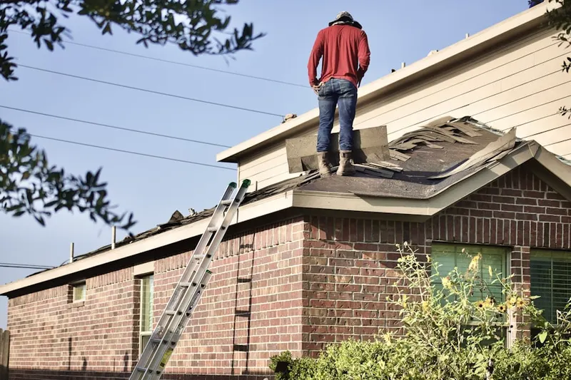 Professional roofer working on a residential roof in Kingsley